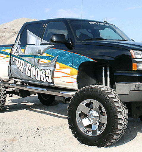 A large truck with multiple accessories and a wrap across the side.