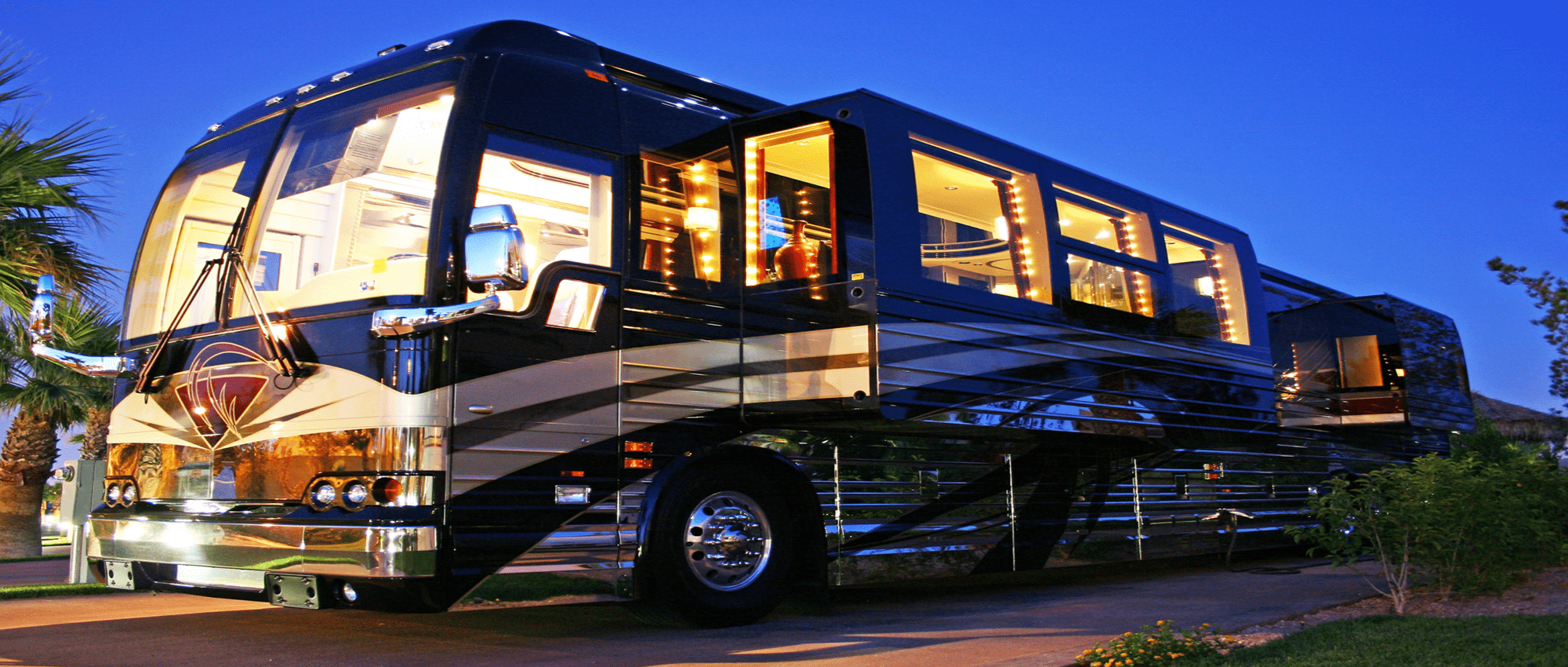 A very large comfortable RV is parked in a driveway.
